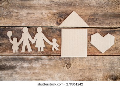 Happy Paper Family With House On Dark Vintage Wooden Background