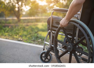 Happy Paralyzed,disabled or handicapped man in hope sitting relax on a wheelchair in nature park.Disabled handicapped man has a hope use smart phone for working,calling and searching for social media - Powered by Shutterstock