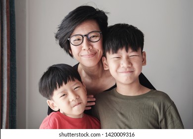 Happy Parent, 40s Mother And Sons, Teen And Young Boy At Home, Happy Asian Family Portrait