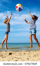 Happy Parent And Child Play A Ball At Coast On A Sunny Summer Day. Beach Sports