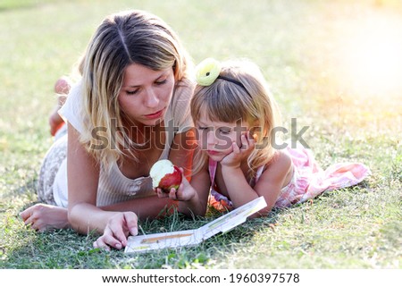 Similar – Reading stories Parenting