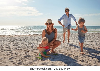 Happy, parents and children playing on the beach on family travel, holiday or adventure in summer. Boy, father and kids with outdoor ocean for fun energy and happiness with a game while running - Powered by Shutterstock