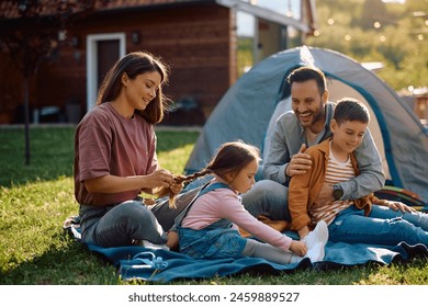 Happy parents enjoying with their kids while camping in nature.  - Powered by Shutterstock