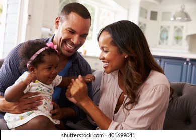 Happy parents playing with baby girl on dadÃ¢??s knee, close-up - Shutterstock ID 401699041