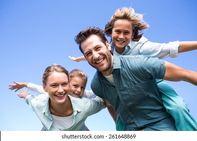 Happy Parents With Their Children In The Countryside