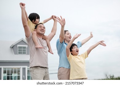 Happy Parents With Their Children. Portrait Of A Cheerful Family. Happy Asian Family