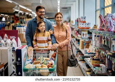 Happy parents with their daughter searching for school supplies while shopping in supermarket. - Shutterstock ID 2195152735