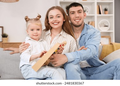 Happy parents and their little daughter with abacus at home - Powered by Shutterstock