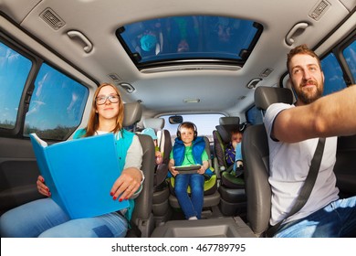 Happy Parents Traveling By Car With Kids