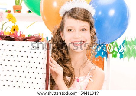 happy party girl with balloons and gift box