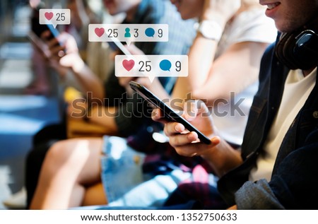 Happy passengers on a subway using social media on their smartphones