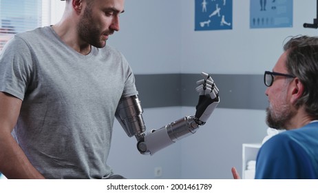 Happy patient learning to use bionic arm near doctor