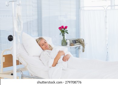 Happy Patient Lying On Her Bed In Hospital