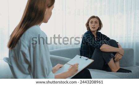 Happy patient and psychologist exchanging mental health conversation in clinic with positive emotion while explaining prim successful work and life to psychologist at psychologist clinic office