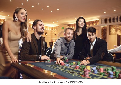 Happy People Are Betting In Gambling At Roulette Poker In A Casino