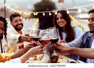 Happy people celebrating summer party toasting with red wine gathered at home terrace. - Powered by Shutterstock