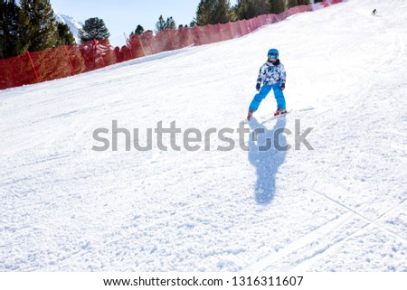 Happy people, children and adults, skiing on a sunny day in Tyrol mountains. Kids having fun while skiing