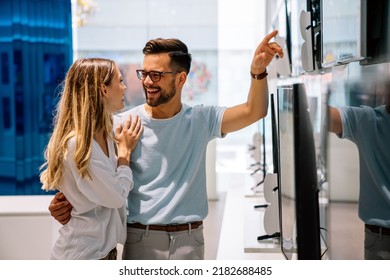 Happy People In Consumer Electronics Retail Store Looking At New Digital Device