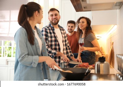 Happy people cooking food together in kitchen - Powered by Shutterstock