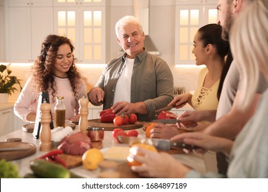 Happy people cooking food together in kitchen - Powered by Shutterstock