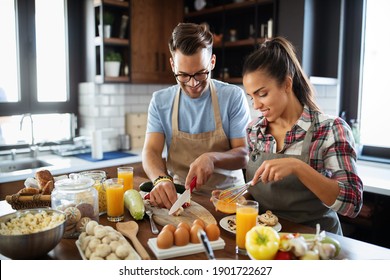 Happy People, Couple Cooking Food Together In Their Loft Kitchen At Home