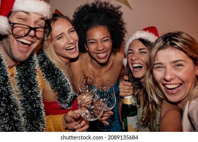 Happy people dancing and laughing on party for New Year's Eve together