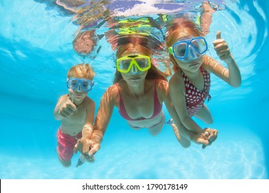 Happy People Dive Underwater With Fun. Funny Photo Of Mother, Kids In Snorkeling Masks In Aqua Park Swimming Pool. Family Lifestyle, Children Water Sport Activity, Lesson With Parent On Summer Holiday