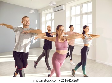 Happy People Doing Fitness Exercises At Gym. Group Of Cheerful, Smiling Friends, Motivated To Stay In Good Shape, Enjoying Dance Workout Class With Professional Instructor. Sport And Dancing Concept