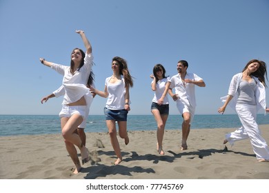 Happy People Group Have Fun  Run And Jump  On Beach Beautiful Sand  Beach