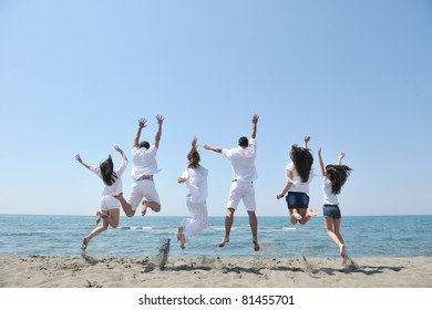 Happy People Group Have Fun  Run And Jump  On Beach Beautiful Sand  Beach