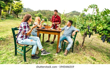 Happy People Having Fun Drinking Red Wine At Vineyard - Young Friends Enjoying Harvest Time Together At Country Side Farm House - Youth Life Style Concept On Warm Filter