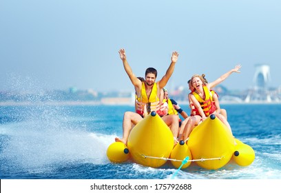 happy people having fun on banana boat