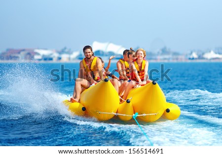 happy people having fun on banana boat