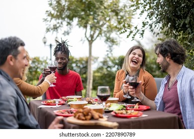 Happy People Having Good Times While Eating Food And Drinking Wine In The Garden, Diversity And Mixed Age Range Concept