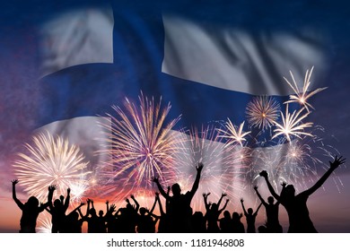Happy people are looking holiday fireworks with flag of Finland in sky, independence day - Powered by Shutterstock