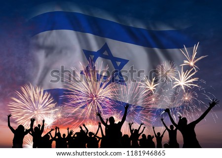 Happy people are looking holiday fireworks with flag of Israel in sky, independence day