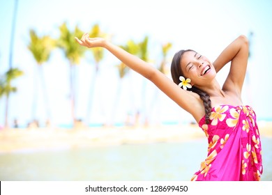 Happy people on beach travel - woman in sarong cheerful in happiness during summer vacation holidays on Hawaii. Multiracial Caucasian / Asian female girl. - Powered by Shutterstock