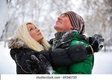 Happy people outdoor in winter park enjoying themselves