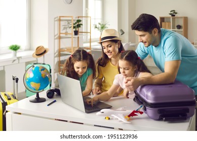 Happy People Planning Holiday Trip. Family Getting Ready For Travel Vacation Using Laptop Computer To Monitor Prices, Pick Airline, Buy Tickets, Purchase Flight, Look For Rentals Or Book Hotel Room