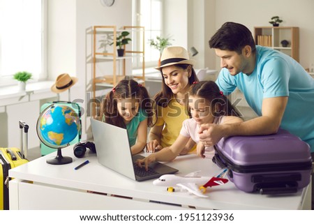 Happy people planning holiday trip. Family getting ready for travel vacation using laptop computer to monitor prices, pick airline, buy tickets, purchase flight, look for rentals or book hotel room