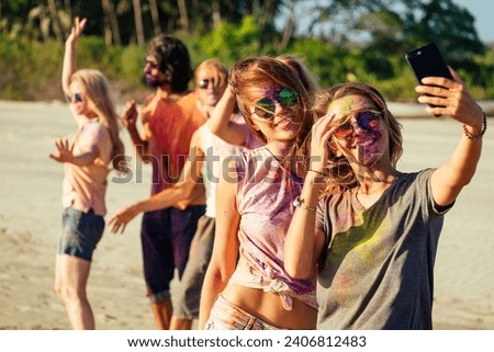 happy people taking self portraits on smartphone in India Goa fest
