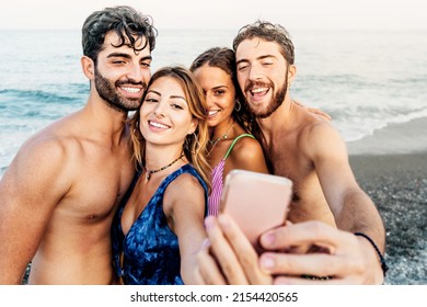 Happy People Taking Selfies On The Beach - Lifestyle Concept Of Happy Friends On Vacation Using Mobile Phone To Capture Moment Snapshot By The Ocean