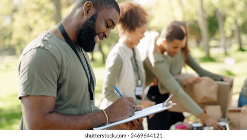 Happy people, volunteer and writing with clipboard for checklist on food, stock or supplies in charity at outdoor park. Man and team working together for NGO, mission or community service in nature - Powered by Shutterstock