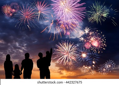 Happy peoples look at holiday fireworks in sky, celebration for family