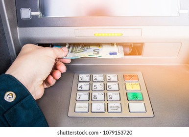 Happy Person Taking Euro Money From ATM Bank Machine. Payday Concept.