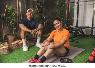 A Happy Personal Trainer And His Pretty Client At An Indoor Garden Converted Intro A Home Gym.