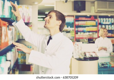 Happy Pharmacist And Pharmacy Technician Posing In Pharmacy