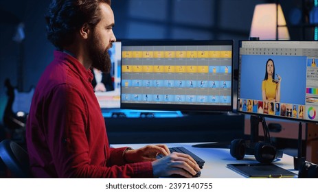 Happy photo editor retouching photographs with editing software on desktop computer, zooming in to find spots that need correcting. Focused photographer in creative workplace adjusting images - Powered by Shutterstock
