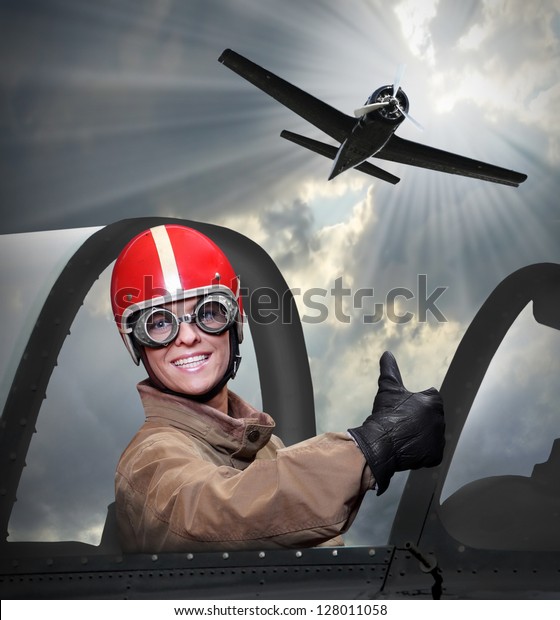Happy pilot in a\
cockpit of a vintage\
plane.