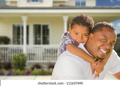 Happy Playful African American Father and Mixed Race Son In Front of House. - Powered by Shutterstock